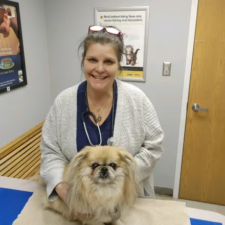 Dr. Kopilak Smiling with a fluffy dog
